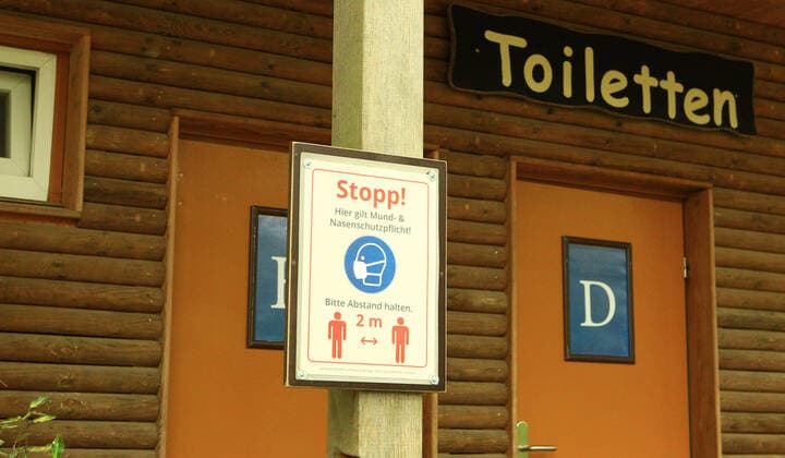A sign in the Schwarze Berge wildlife park in Rosengarten, Lower Saxony, informs visitors that masks are compulsory in the toilet area of the park south of Hamburg Rosengarten Lower Saxony