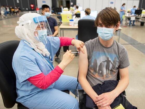 May 13, 2021, Montreal, PQ, Canada: Bertrand Legane, 30, receives a dose of the Pfizer vaccine at a COVID-19 vaccination clinic, Thursday, May 13, 2021 in Montreal. Montreal Canada  - ZUMAc35_ 20210513_zaf_c35_026 Copyright: xRyanxRemiorzx