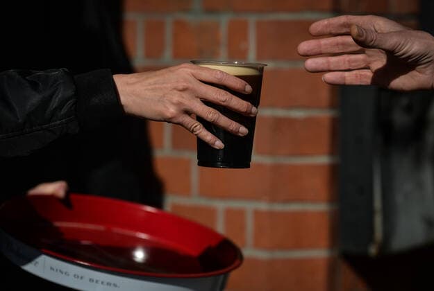 Daily Life In Dublin A person holds a pint of Guinness in a plastic cup on the street in Dublin s city center. On Thursday, 13 May 2021, in Dublin, Ireland. Dublin Ireland widak-dailydub210513_npdCc  Copyright: xArturxWidakx