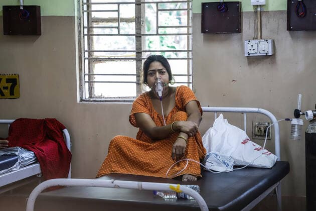 May 14, 2021, Kolkata, West Bengal, India: A woman who has been tested positive for COVID-19 disease sits on a bed inside the COVID-19 ward at Baruipur Super speciality hospital..People of India are going through crisis of beds and oxygen cylinders during the second wave of COVID-19 pandemic which is worse than the previous one. Kolkata India - ZUMAs197 20210514_zaa_s197_011 Copyright: xJitxChattopadhyayx