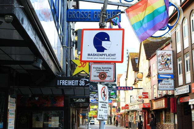 A sign in the street Große Freiheit on St Pauli informs visitors that masks are compulsory at certain times St Pauli Hamburg