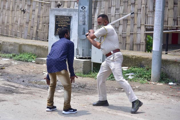 Coronavirus Emergency In India A police officer wields his baton against a man as a punishment for defied curfew due to rise of COVID-19 coronavirus cases in Nagaon District of Assam ,India on May 16,2021. Nagaon India hazarika-notitle210516_npUyt  Copyright: xAnuwarxHazarikax