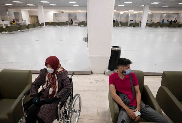 Day-3 Of Mass General COVID-19 Vaccination In The Iran Grand Bazaar, Iran Mall, In Western Tehran An Iranian man sits next to his elderly mother (L) who waits to receive a dose of the China s Sinopharm new coronavirus disease (COVID-19) vaccine on day-3 of the mass general COVID-19 vaccination in the Iran Grand Bazaar (Market), Iran Mall, in western Tehran on May 17, 2021. Tehran Tehran Iran nikoubazl-day3ofma210517_npgQ6  Copyright: xMortezaxNikoubazlx