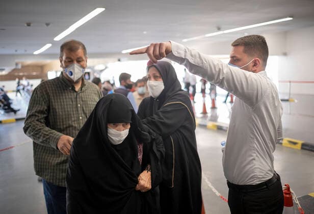 Day-3 Of Mass General COVID-19 Vaccination In The Iran Grand Bazaar, Iran Mall, In Western Tehran An Iran Mall staff member (R) points at as an elderly woman wearing a protective face mask walks to enter the main vaccination hall to receive a dose of the China s Sinopharm new coronavirus disease (COVID-19) vaccine on day-3 of the mass general COVID-19 vaccination in the Iran Grand Bazaar (Market), Iran Mall, in western Tehran on May 17, 2021. Tehran Tehran Iran nikoubazl-day3ofma210517_npTBe  Copyright: xMortezaxNikoubazlx