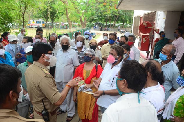 May 17, 2021, Prayagraj, Uttar Pradesh, India: Prayagraj: Policeman talk with beneficiaries as they demonstrate against lack of vaccine during second wave of CORONAVIRUS in Prayagraj on Monday, May 17, 2021. Prayagraj India - ZUMAv115 20210517_zap_v115_008 Copyright: xPrabhatxKumarxVermax
