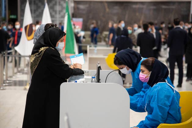 Iran: Vaccination of People over 75 years An Iranian medical personnel wearing a protective suit talks to a woman to receive a dose of the new coronavirus disease (COVID-19) vaccine in Iranmall shopping complex in northwest of Tehran. Tehran Iran Iranmall Copyright: SobhanxFarajvan