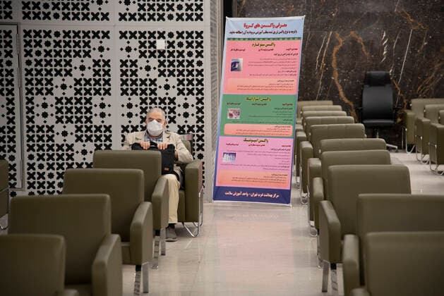 Iran: Vaccination of People over 75 years an Iranian elderly man wearing protective face masks sit in a hall while waiting to receive a dose of the new coronavirus disease (COVID-19) vaccine in Iranmall shopping complex in northwest of Tehran. Tehran Iran Iranmall Copyright: SobhanxFarajvan