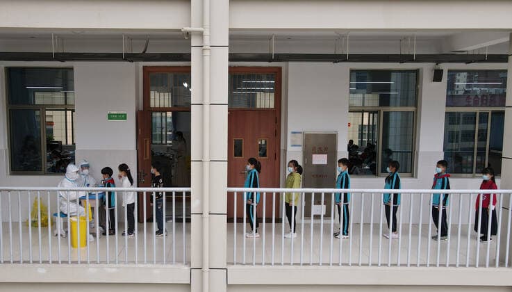 (210517) -- LU AN, May 17, 2021 -- Aerial photo taken on May 17, 2021 shows medical workers collecting swab samples of students for nucleic acid testing at a primary school in Lu an, east China s Anhui Province. Lu an started to conduct a second round of nucleic acid testing for people in the city s main districts and in key areas from Monday to Wednesday, according to the commission. Authorities conducted the first round of testing from May 14 to 16 in the city proper, with more than 1 million samples collected. ) CHINA-ANHUI-LU AN-COVID-19-TEST (CN) ZhouxMu 
