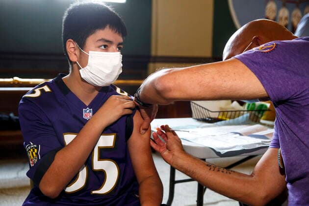 May 17, 2021, Winnipeg, mb, Canada: Dr. Barry Lavallee, CEO, Keewatinowi Inniniw Minoayawin, administers the Pfizer-BioNTech vaccine to Alexander Herrera, 14, at the Aboriginal Health and Wellness Centre in Winnipeg, Monday, May 17, 2021. Winnipeg Canada - ZUMAc35_ 20210517_zaf_c35_018 Copyright: xMikexDealx