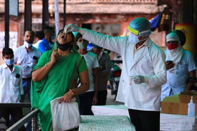 COVID-19 Testing In Jaipur A health worker collects swab sample of a woman during the COVID-19 testing, amid in surge of coronavirus cases in Jaipur, Rajasthan, India, Monday, May 17,2021. Jaipur Rajasthan India bhatnagar-notitle210517_npIgF  Copyright: xVishalxBhatnagarx