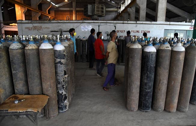 May 17, 2021, Guwahati, Assam, India: Workers busey in filing oxygen gas cylinders in Oxygen Gas filling station during surge in COVID-19 in the state in Guwahati Assam India on Tuesday 17th May 2021. Guwahati India - ZUMAd163 20210517_zip_d163_017 Copyright: xDasarathxDekax
