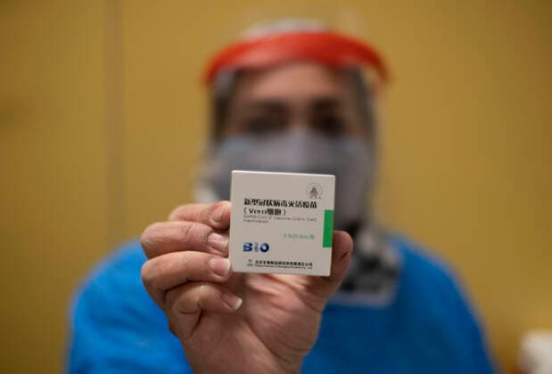 Virus Outbreak Iran Iranian medical personnel wearing a protective suit holds a box of the China s Sinopharm new coronavirus disease (COVID-19) vaccine, as he stands at the main vaccination hall in the Iran Grand Bazaar, Iran Mall, on day-3 of the mass general COVID-19 vaccination in western Tehran on May 17, 2021. Tehran Tehran Iran nikoubazl-day3ofma210517_npCGL  Copyright: xMortezaxNikoubazlx
