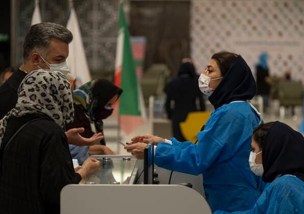 Virus Outbreak Iran Iran Grand Bazaar, iran Mall, staff member wearing a protective face mask (2nd R) speaks with a man who has brought his elderly mother for receiving a dose of the China s Sinopharm new coronavirus disease (COVID-19) vaccine on day-3 of the mass general COVID-19 vaccination in western Tehran on May 17, 2021. Tehran Tehran Iran nikoubazl-day3ofma210517_npNxW  Copyright: xMortezaxNikoubazlx