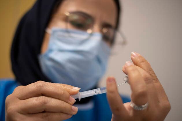 Virus Outbreak Iran Iranian medical personnel wearing a protective suit loads a syringe with the China s Sinopharm new coronavirus disease (COVID-19) vaccine, in the Iran Grand Bazaar, Iran Mall, on day-3 of the mass general COVID-19 vaccination in western Tehran on May 17, 2021. Tehran Tehran Iran nikoubazl-day3ofma210517_npVPM  Copyright: xMortezaxNikoubazlx