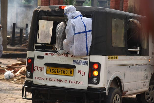 May 19, 2021, Guwahati, Guwahati, India: Health worker sit on a vehicle which brought victims who died in COVID-19 for last rites as coronavirus surge in the state in Guwahati Assam India on Wednesday 19th May 2021. Guwahati India - ZUMAd163 20210519_zip_d163_006 Copyright: xDasarathxDekax