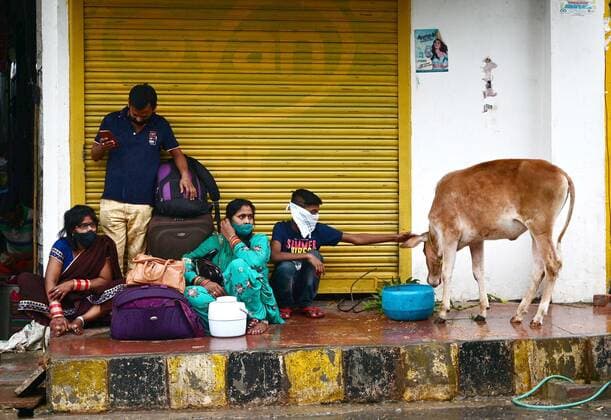 May 19, 2021, Prayagraj, Uttar Pradesh, India: Prayagraj: Commuter take shelter in front of closed shop during rain shower in Prayagraj on Wednesday, May 19, 2021. Prayagraj India - ZUMAv115 20210519_zap_v115_011 Copyright: xPrabhatxKumarxVermax