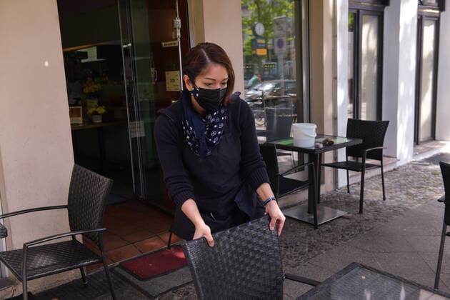 Berlin, Germany 21 May 2021 Outdoor restaurants in Berlin are allowed to reopen after a lockdown to combat the Corona pandemic An employee of the restaurant cleans the chairs and tables after a month-long hiatus in Winterfeldtstrasse Berlin Copyright: xFotostandx xReuhlx