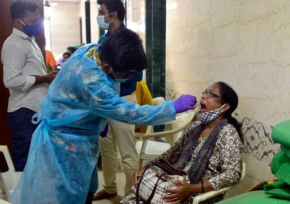 MUMBAI, INDIA - MAY 21: A medical staff conducts RT-PCR test of a resident at Siddhant Balwadi, Parel, on May 21, 2021 in Mumbai, India. (Photo by Anshuman Poyrekar Hindustan Times) Medical Team Conducts COVID-19 Coronavirus Test