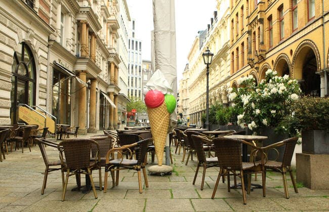 Empty outdoor area of an ice cream parlour in the city centre immediately after opening in Hamburgs filthy weather In Hamburg, the Corona measures have been relaxed due to falling insidence values Retailers and outdoor caterers are allowed to reopen under conditions after more than half a year Old Town Hamburg