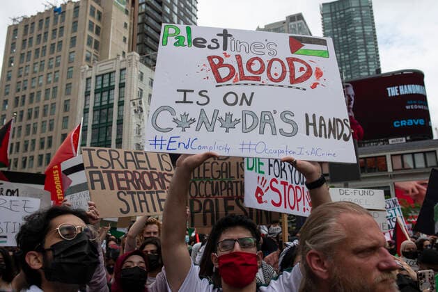May 22, 2021, Toronto, Ontario, Canada: Pro-Palestinian protestors gather on the streets of Toronto, less than 48 hours after ceasefire took effect. More than 11 days of bloodshed claimed the lives of at least 230 Palestinians and 12 Israelis, and brought widespread devastation to critical infrastructure in the Hamas-ruled Gaza Strip. Toronto Canada - ZUMAc232 20210522_zip_c232_002 Copyright: xGilesxCampbellx