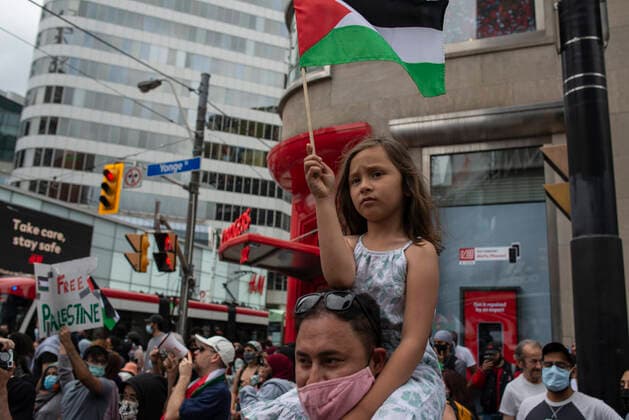 May 22, 2021, Toronto, Ontario, Canada: A child waves a Palestinian flag at a pro-Palestinian protest on the streets of Toronto, less than 48 hours after ceasefire took effect. More than 11 days of bloodshed claimed the lives of at least 230 Palestinians and 12 Israelis, and brought widespread devastation to critical infrastructure in the Hamas-ruled Gaza Strip. Toronto Canada - ZUMAc232 20210522_zip_c232_018 Copyright: xGilesxCampbellx
