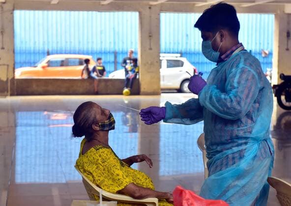 MUMBAI, INDIA - MAY 22: A BMC medical staff collects a swab sample for Covid-19 test, at Sewri, on May 22, 2021 in Mumbai, India. (Photo by Anshuman Poyrekar Hindustan Times) Medical Team Conducts COVID-19 Coronavirus Test