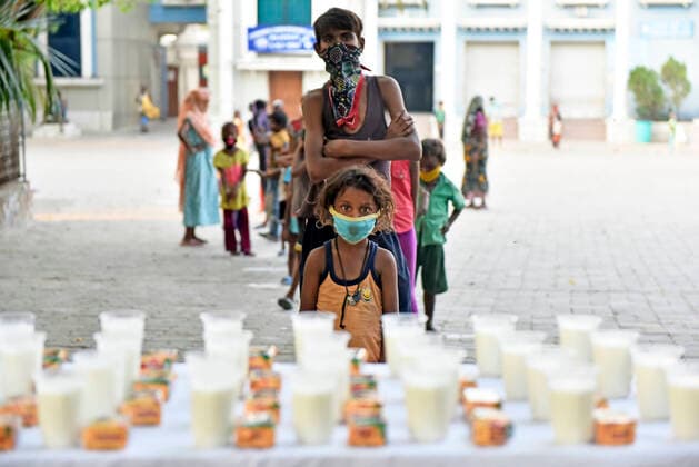 Coronavirus Emergency In Kolkata Poor children stands in a line during a free glass of milk and biscuit packet distribution organised by Kolkata police amid coronavirus emergency in Kolkata, India, 23 May, 2021. India has surpassed Nigeria when it comes to having the largest population of people living in extreme poverty. India added another 85 million poor to its existing huge numbers that have somehow been surviving below the poverty line. The devastating second wave of Covid-19 may leave a still bigger dent in poverty estimates according to an Indian media report. Kolkata West Bengal India aditya-notitle210523_np0L4  Copyright: xIndranilxAdityax