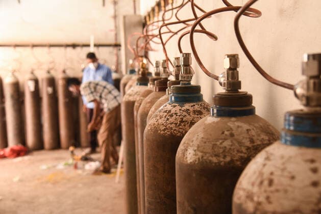May 23, 2021, Guwahati, India: Workers at an oxygen filling station at Gauhati Medical College and Hospital, in Guwahati, India on May 23, 2021. Cities and towns of India struggled to keep COVID-19 coronavirus patients breathing amid a severe oxygen shortage. Guwahati India - ZUMAt232 20210523_zip_t232_003 Copyright: xDavidxTalukdarx