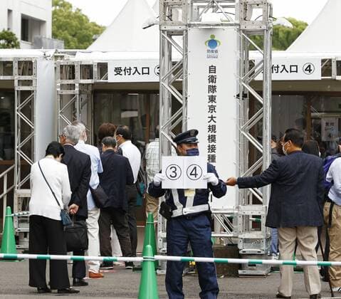 Mass vaccination center in Tokyo Senior citizens wait in line at the entrance of a newly opened mass coronavirus vaccination center in Tokyo on May 24, 2021. 