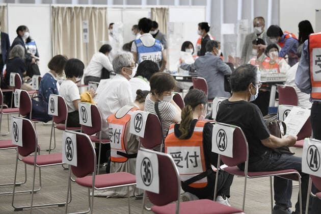 Mass vaccination center in Osaka Senior citizens wait to receive a coronavirus vaccine shot at a newly opened mass vaccination center in Osaka on May 24, 2021. (Pool photo) 