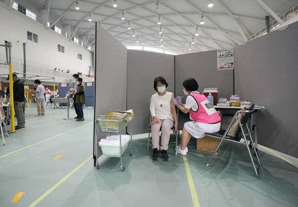 Mass vaccination center in Aichi A senior citizen receives the Moderna coronavirus vaccine at Fujita Health University gymnasium, a newly opened mass vaccination center, in the Aichi Prefecture city of Toyoake, central Japan, on May 24, 2021. (No trimming allowed) 