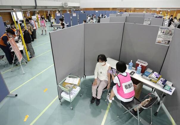 Mass vaccination center in Aichi A senior citizen receives the Moderna coronavirus vaccine at Fujita Health University gymnasium, a newly opened mass vaccination center, in the Aichi Prefecture city of Toyoake, central Japan, on May 24, 2021. (No trimming allowed) 