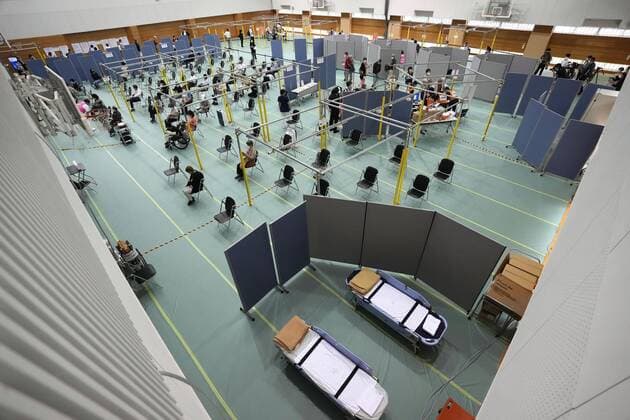 Mass vaccination center in Aichi Senior citizens wait to receive the Moderna coronavirus vaccine at Fujita Health University gymnasium, a newly opened mass vaccination center, in the Aichi Prefecture city of Toyoake, central Japan, on May 24, 2021. (No trimming allowed) 