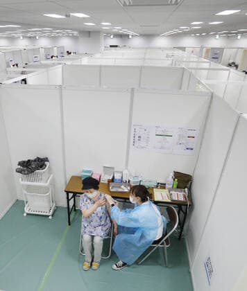 Large vaccination center in Sendai A senior citizen receives coronavirus vaccine at a newly opened large vaccination center near Sendai Station in Miyagi Prefecture, northeastern Japan, on May 24, 2021. 
