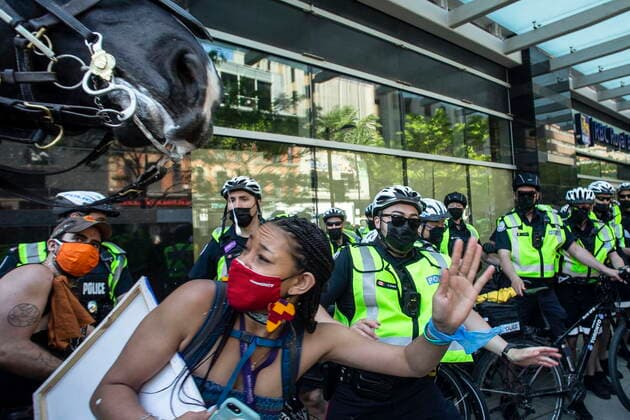 May 24, 2021, Toronto, on, Canada: A protester moves to avoid a police horse, following the arrest of an organizer, as demonstrators mark the first anniversary of the death of Regis Korchinski-Paquet, the 29-year-old African Indigenous woman who died in the presence of Toronto police officers, in Toronto on Monday, May 24, 2021. Toronto Canada - ZUMAc35_ 20210524_zaf_c35_019 Copyright: xChrisxYoungx
