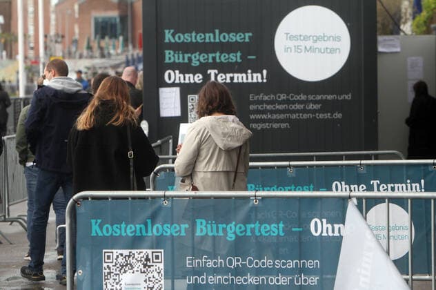 Crowd of people wanting to take a free Corona rapid test at a container testing centre the Kasematten on the banks of the Rhine in Düsseldorf, North Rhine Westphalia, Germany