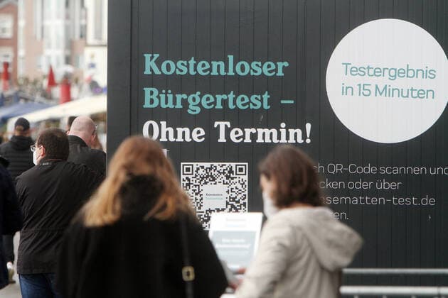 Crowd of people wanting to take a free Corona rapid test at a container testing centre the Kasematten on the banks of the Rhine in Düsseldorf, North Rhine Westphalia, Germany
