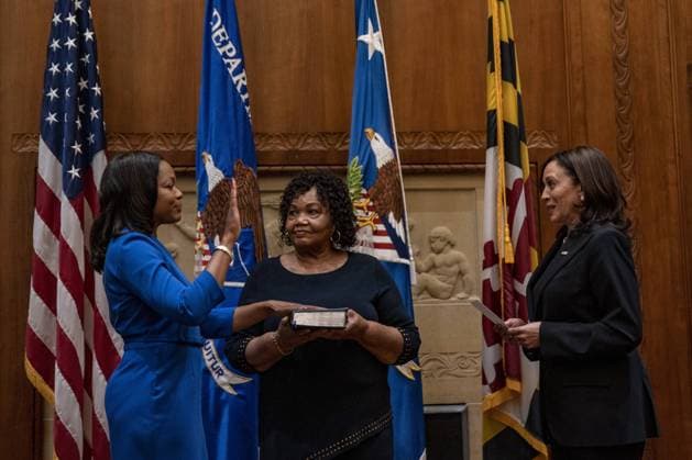 Kristen Clarke holds her hand up; as her mom Pansy Clarke holds a bible; as Vice President Kamala Harris swears her in at the Department of Justice in Washington, DC on Tuesday, May 25, 2021. Kristen Clarke was confirmed on Tuesday as the first black women to lead the Justice Departments Civil Rights Division.  WAP20210525030 TASOSxKATOPODIS