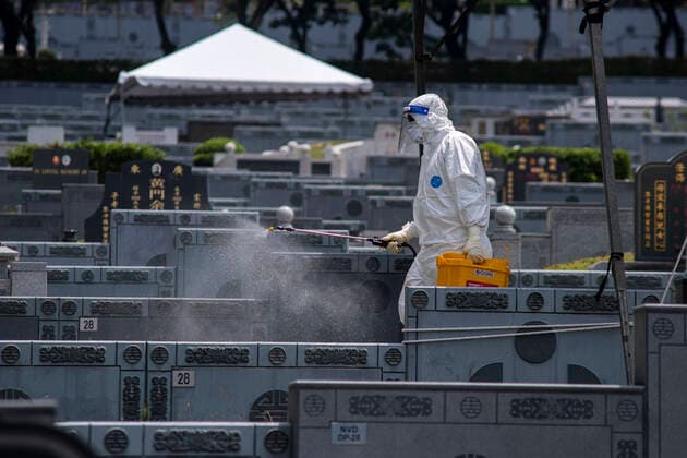 (210526) -- SEMENYIH, May 26, 2021 -- A man in protective suits disinfects a graveyard where COVID-19 victims are buried in Semenyih, Selangor, Malaysia, May 26, 2021. Malaysia on Wednesday reported the highest daily spike of new confirmed COVID-19 cases and deaths since the start of the pandemic, the Health Ministry said. As many as 7,478 new COVID-19 infections were reported, bringing the national total to 533,367. Another 63 deaths have been reported, the highest in a single day, pushing the total deaths to 2,432. (Photo by Xinhua) MALAYSIA-COVID-19-CASES ChongxVoonxChung 