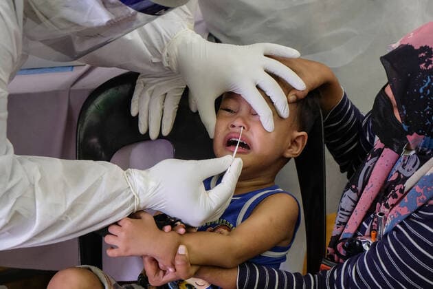 May 26, 2021, Sungai Buloh, Malaysia: A health worker wearing a personal protective equipment suit (PPE) is seen taking a nasal swab sample from a child during the COVID19 testing at a test center in Sungai Buloh..Malaysia has recorded the highest daily cases of Covid-19, yesterday with a record of 7,289 cases. Selangor government continues to conduct mass COVID19 screening tests over the state to battle the coronavirus pandemic. Sungai Buloh Malaysia - ZUMAs197 20210526_zaa_s197_003 Copyright: xFarisxHadziqx