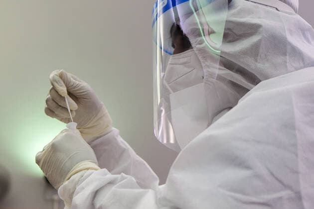 May 26, 2021, Sungai Buloh, Malaysia: A healthcare worker wearing a personal protective equipment suit (PPE) seen with a specimen after taking a nasal swab from a person at a test center in Sungai Buloh..Malaysia has recorded the highest daily cases of Covid-19, yesterday with a record of 7,289 cases. Selangor government continues to conduct mass COVID19 screening tests over the state to battle the coronavirus pandemic. Sungai Buloh Malaysia - ZUMAs197 20210526_zaa_s197_011 Copyright: xFarisxHadziqx