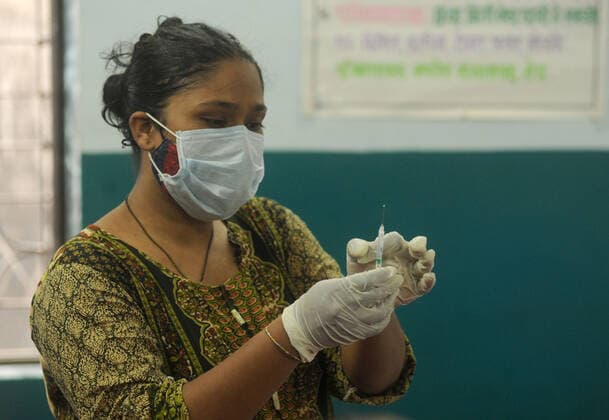 MUMBAI, INDIA - MAY 28: A healthcare worker fills a syringe with vaccine to inoculate beneficiaries against Covid-19 at BMC School Vaccination Centre, in Hanuman Nagar, Kandivali East, on May 28, 2021 in Mumbai, India. (Photo by Vijay Bate Hindustan Times ) COVID-19 Vaccination Drive