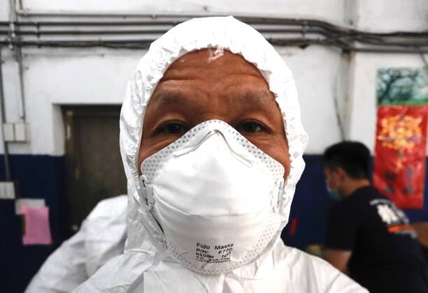 May 29, 2021, Taipei, Taipei, Taiwan: A special quarantine bus driver puts on a PPE at a fire station, where buses and taxis that carried quarantined persons are spread with disinfectant, before delivering citizens who have completed their quarantine, following a surge of domestic COVID-19 cases. The number of domestic COVID-19 cases particularly in Taipei has surged, with disinfection being intensified across the country to minimize transmission. Taipei Taiwan - ZUMAs313 20210529_zip_s313_020 Copyright: xDanielxCengxShou-Yix