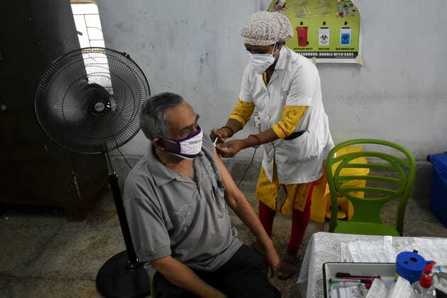 India: Covid-19 vaccination in Kolkata A person receives a dose of Covishield (Covid-19 vaccine) inside a West Bengal state Health Vaccination centre in Kolkata. Kolkata West Bengal India Copyright: SudiptaxDas