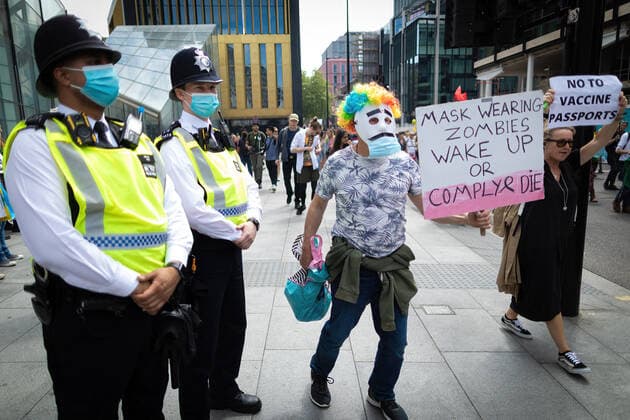 May 29, 2021, London, United Kingdom: A protester holding a placard marches past police officers during an anti-lockdown protest..Thousands of people came out under the banner to Unite for Peace and their Human Rights. The number of people attending the protests has increased month on month since the introduction of the COVID-19 restrictions. London United Kingdom - ZUMAs197 20210529_zaa_s197_062 Copyright: xAndyxBartonx