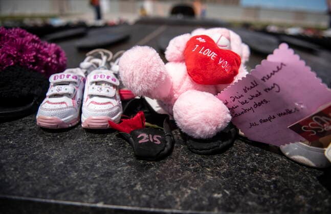 May 30, 2021, Ottawa, on, Canada: The number 215 is written on a pair of moccasins laid at the Centennial Flame on Parliament Hill in Ottawa in memory of the 215 children whose remains were found at the grounds of the former Kamloops Indian Residential School at TkÃ¢â‚¬â ¢emlups te Secwo pemc First Nation in Kamloops, B.C., on Sunday, May 30, 2021, Ottawa Canada  - ZUMAc35_ 20210530_zaf_c35_044 Copyright: xJustinxTangx