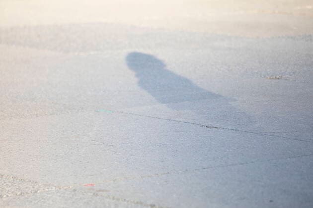 May 30, 2021, Toronto, on, Canada: A shadow is cast during a vigil in Toronto on Sunday May 30, 2021, for the 215 Indigenous children, whose remains were uncovered on the grounds of a former residential school near Kamloops, British Columbia. The discovery of a mass grave was announced late on Thursday by the TkÃ¢â‚¬â ¢emlups te Secwo pemc people after the site was examined by a team using ground-penetrating radar. Toronto Canada  - ZUMAc35_ 20210530_zaf_c35_107 Copyright: xChrisxYoungx