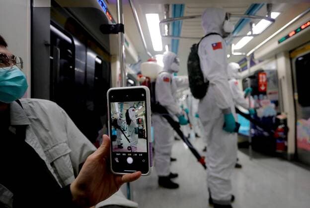 May 31, 2021, Taipei, Taipei, Taiwan: A lady takes pictures of the military officers in protective suits disinfecting public areas and transport in Taipei, following a dramatic surge of domestic cases that jeopardize medical systems in Taiwan. With more Covid-19 related cases and deaths reported, there has been discussion on the possibility of lockdown while facing inadequate vaccines and impacts on the economy. Taipei Taiwan - ZUMAs313 20210531_zip_s313_020 Copyright: xDanielxCengxShou-Yix