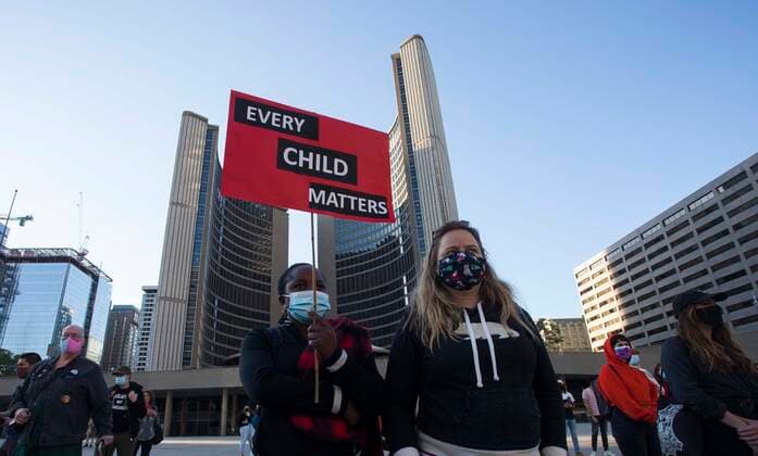 (210531) -- TORONTO, May 31, 2021 -- A woman shows a placard with words EVERY CHILD MATTERS as she takes part in a memorial event for the 215 children whose remains have been found buried at a former Kamloops residential school in Toronto, Canada, May 30, 2021. The reported discovery of the remains of 215 indigenous children at a former residential school in Kamloops in western Canada has shocked Canadian people. (Photo by Xinhua) CANADA-TORONTO-KAMLOOPS INDIGENOUS SCHOOL-CHILDREN REMAINS-MEMORIAL ZouxZheng 