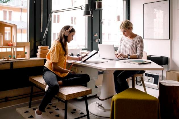 Businesswoman working while daughter learning through digital tablet at home Sweden, Stockholm, model released, property released Copyright: xMaskotx , MA86571